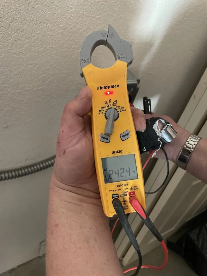 Voltage testing with clamp meter during Recessed Lighting Installation in Mesa
